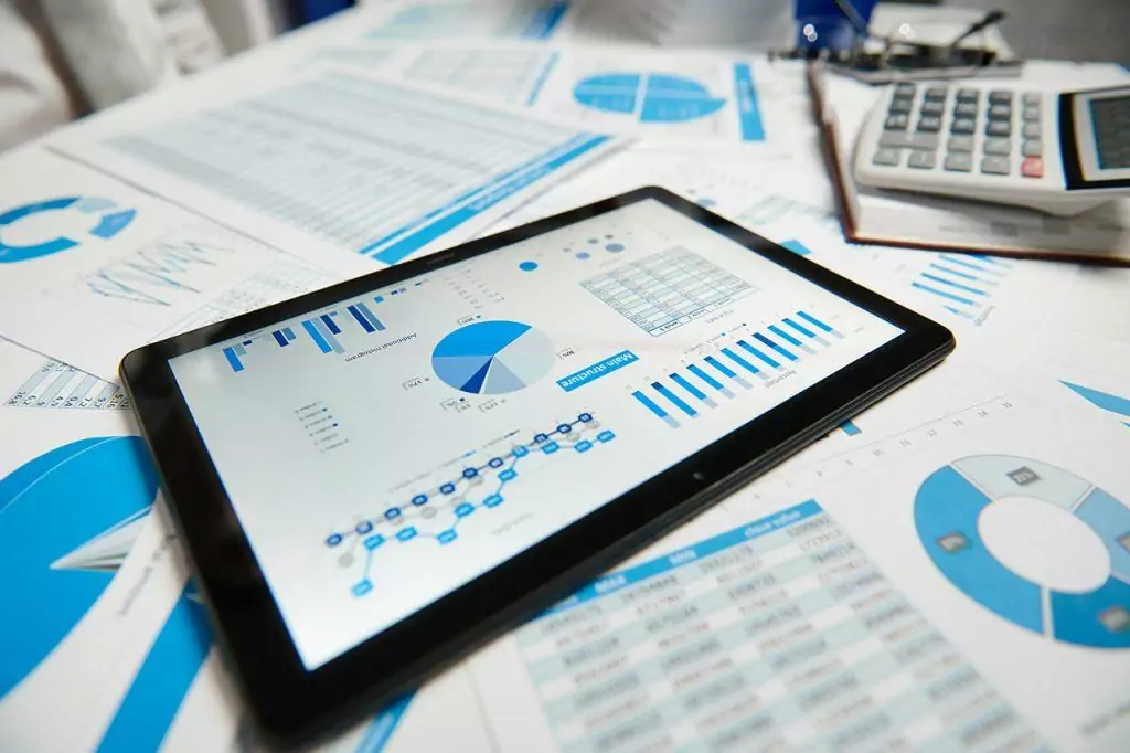 Office workspace for business. Tablet pc and reports. Table closeup. Business financial accounting concept.