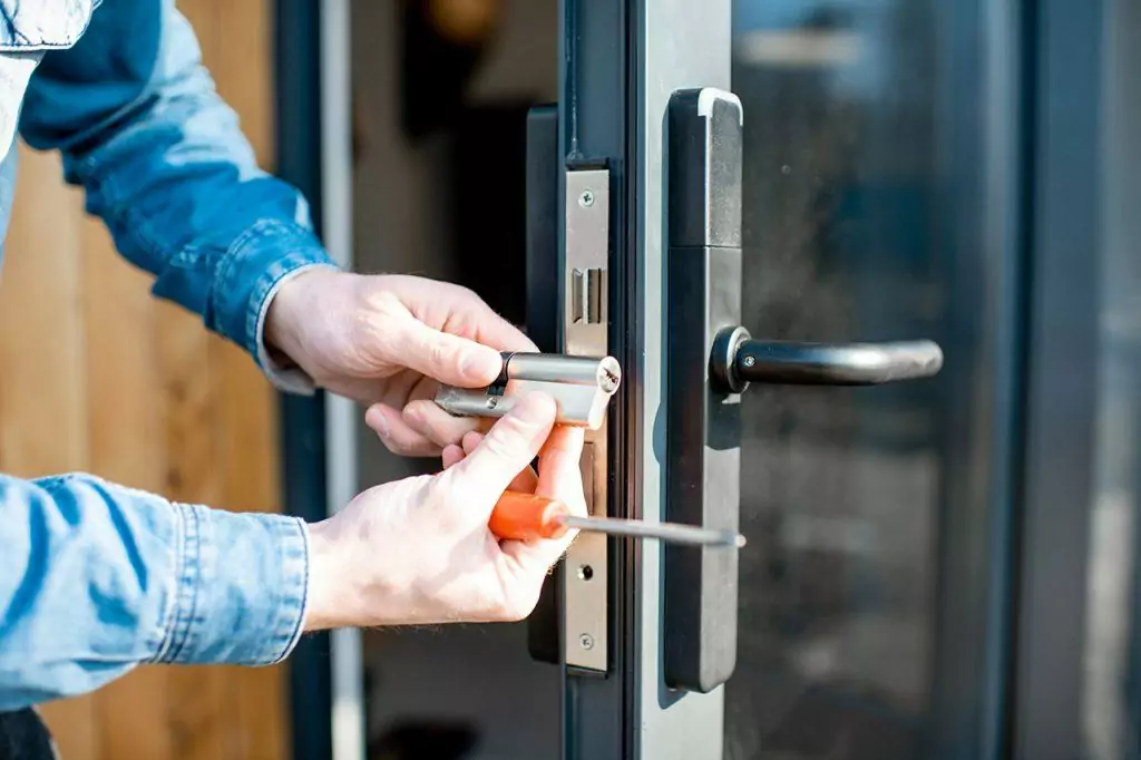 Man changing core of a door lock